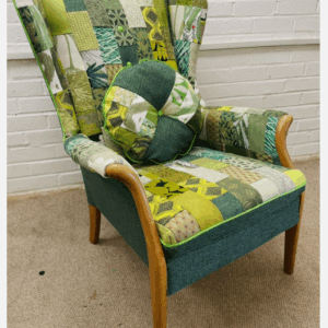 Parker Knoll wingback chair upholstered in green patchwork design
